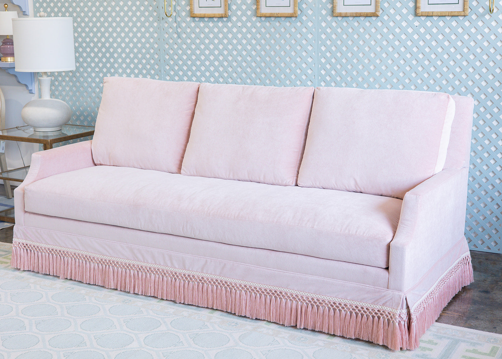 Velvet Pink Sofa with pink fringe and a scallop arm