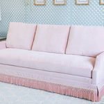 Velvet Pink Sofa with pink fringe and a scallop arm