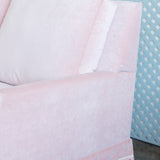 Velvet Pink Sofa with pink fringe and a scallop arm