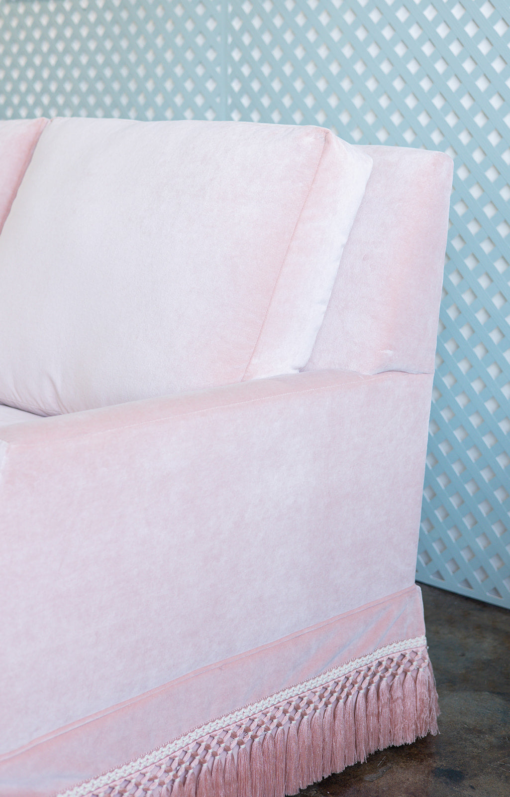 Velvet Pink Sofa with pink fringe and a scallop arm