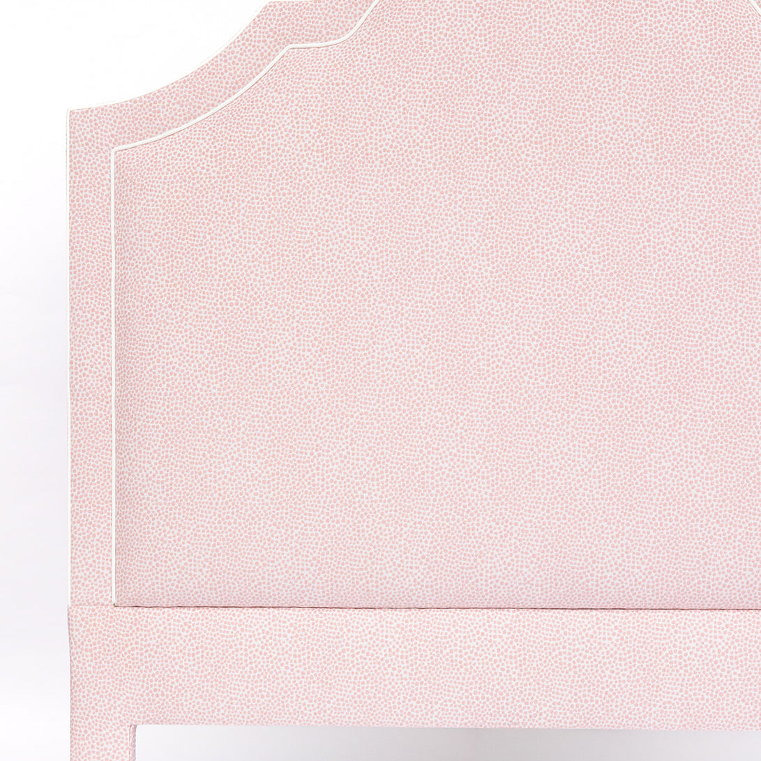 Pink upholstered headboard on a white background