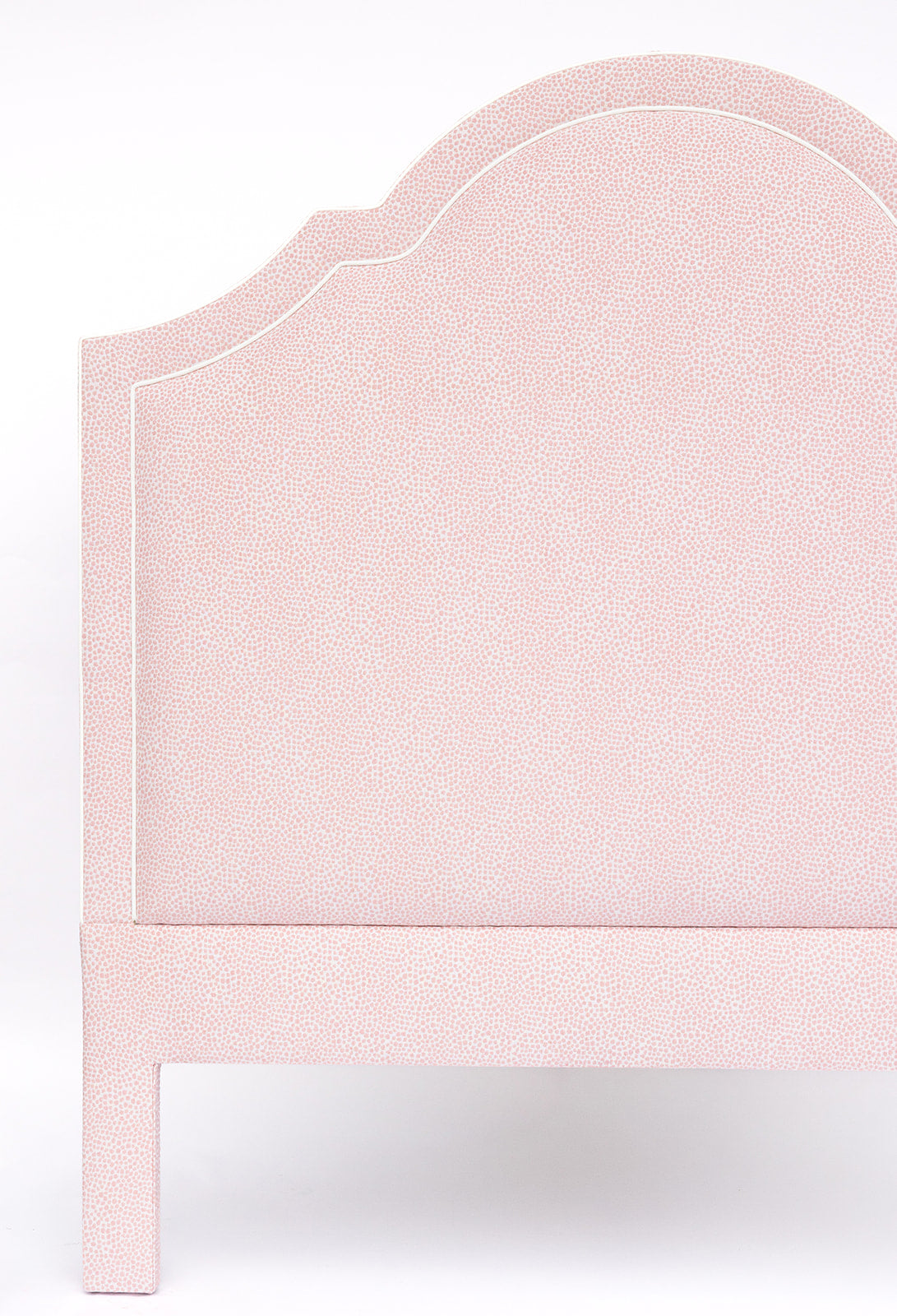 Pink upholstered headboard on a white background
