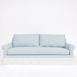 Light blue sofa with white fringe 