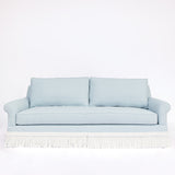 Light blue sofa with white fringe 