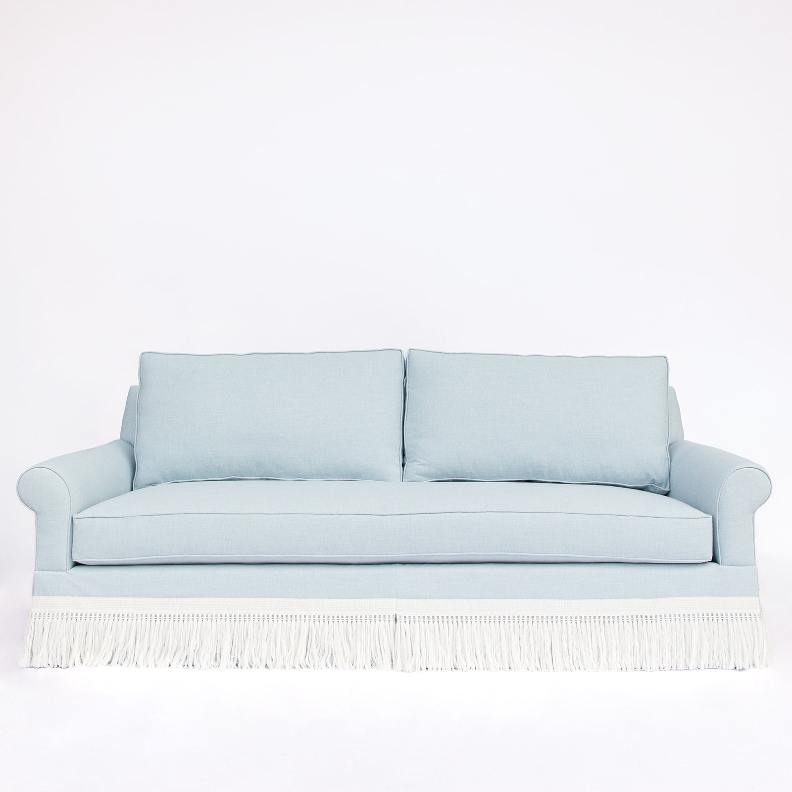Light blue sofa with white fringe 
