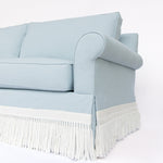 Light blue sofa with white fringe