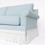Light blue sofa with white fringe